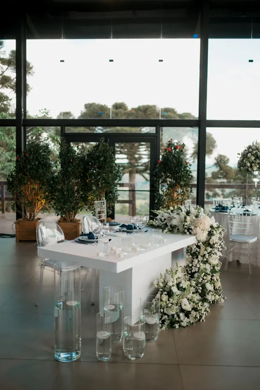 White florals and transparent glass decor in a modern reception