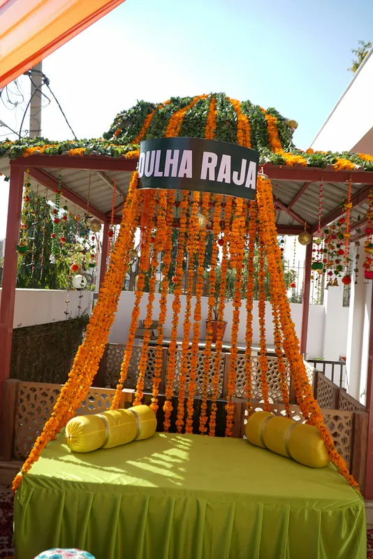 An Indian wedding seating vignette with marigold garlands